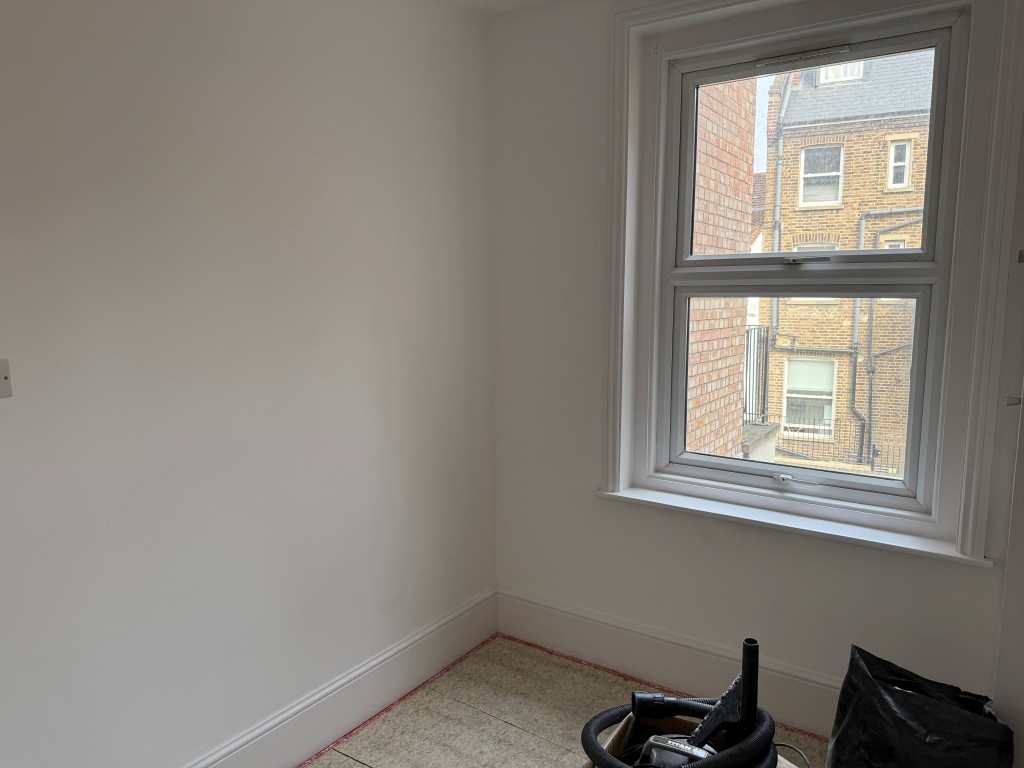 Lot: 196 - TWO-BEDROOM BALCONY FLAT IN CENTRAL LOCATION - Rear bedroom two with window